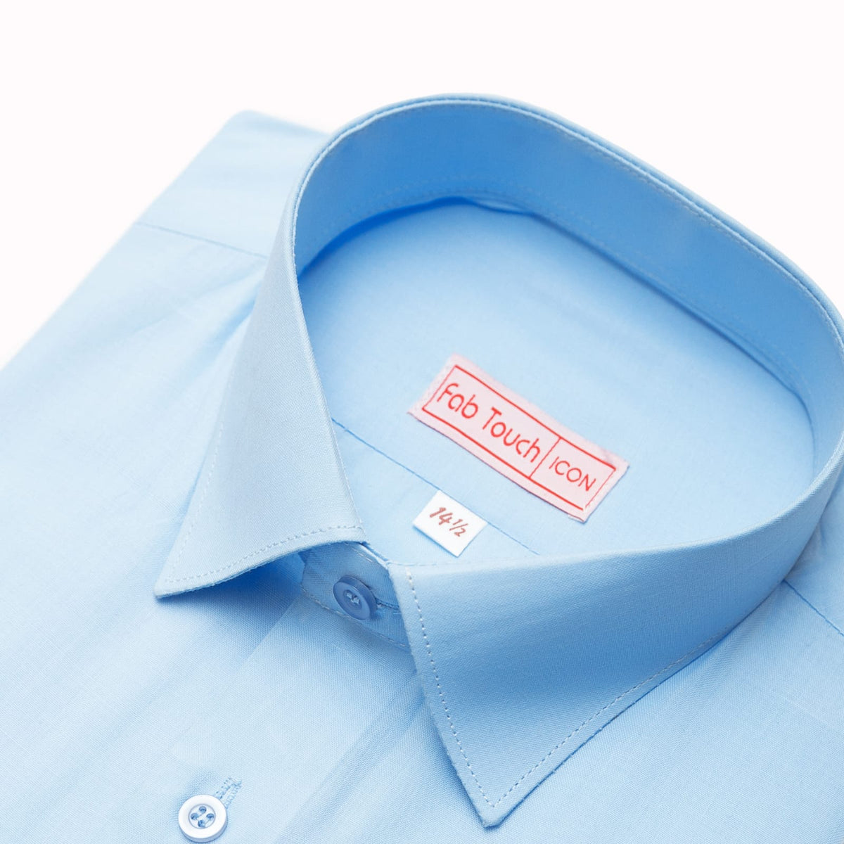A close-up of a light blue dress shirt collar with a visible Fab Touch icon label inside the neck, on a clean white background.