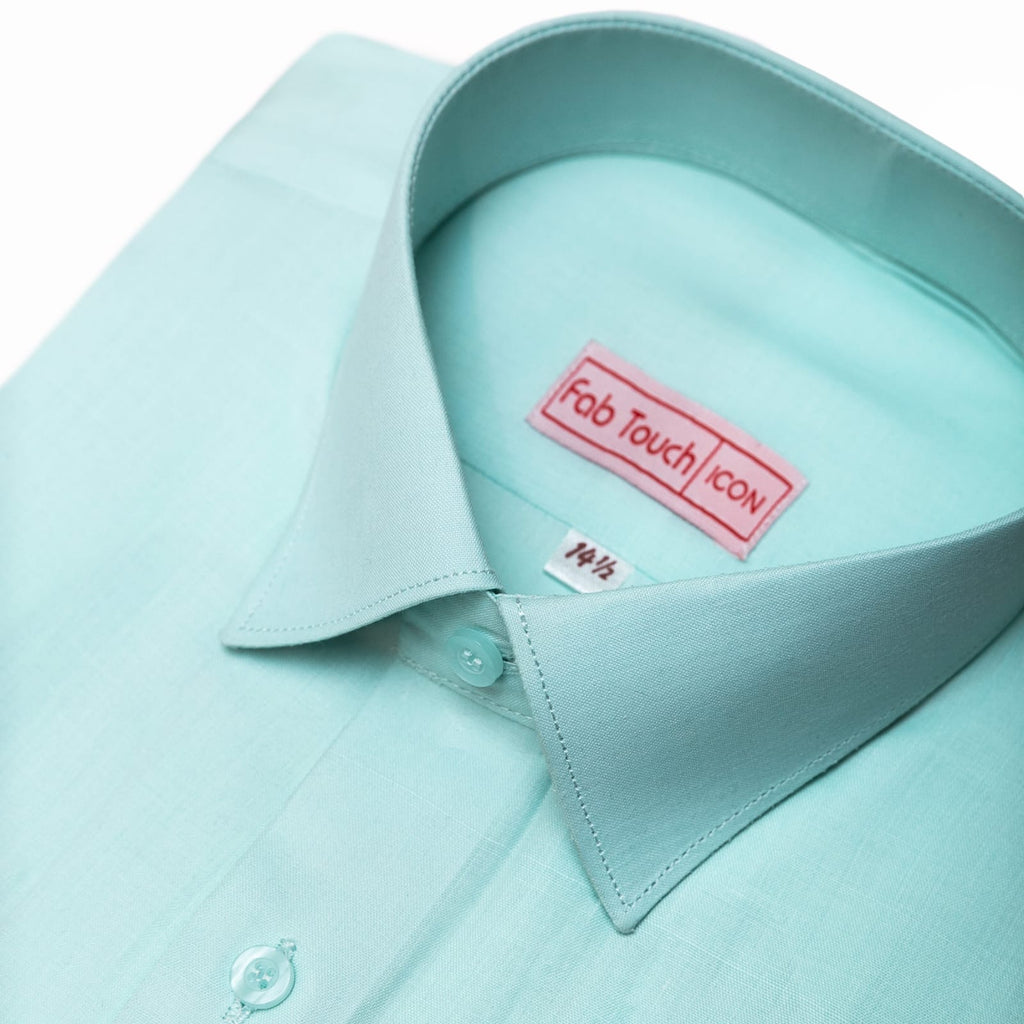 A close-up of a light mint green dress shirt showing the collar, buttoned placket, and the inner neck label which reads 'Fab Touch icon'.